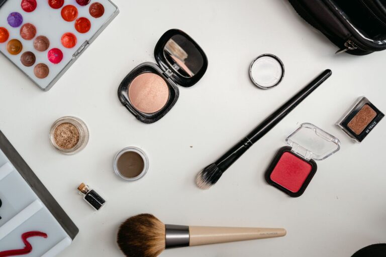 Professional makeup kit with brushes, foundations and palettes laid out for a working artist