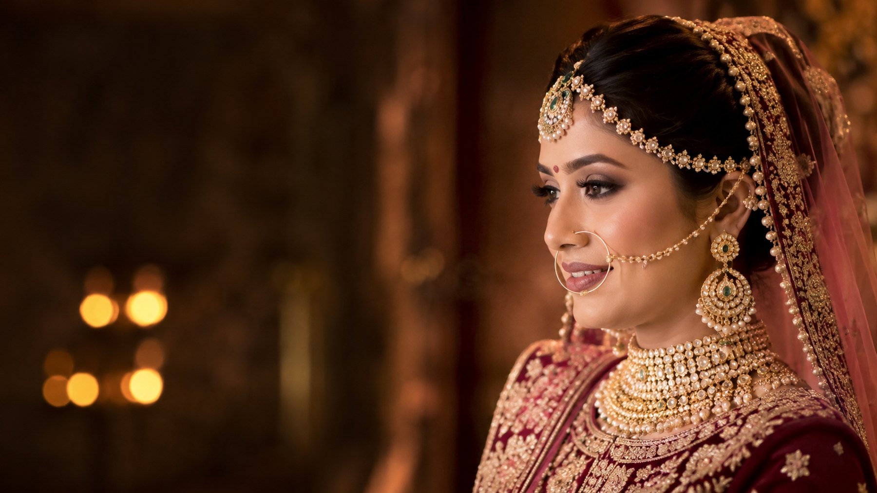 Bride in red and gold bridal makeup with kundan jewellery, created on the bridal makeup course in Hyderabad