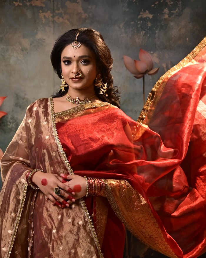 Modern silk saree drape with a loose flowing pallu and gold border