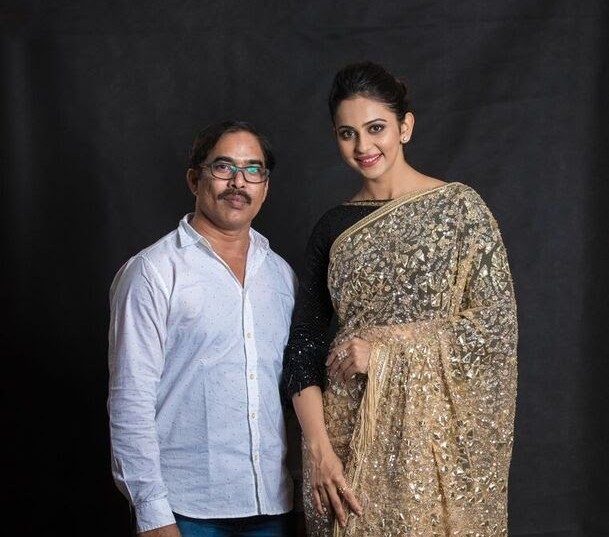 Warm gold saree studio look showing analogous colour harmony in makeup and styling