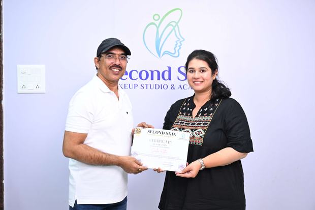 A student receiving her certificate of achievement from Chakravarthi Kadali